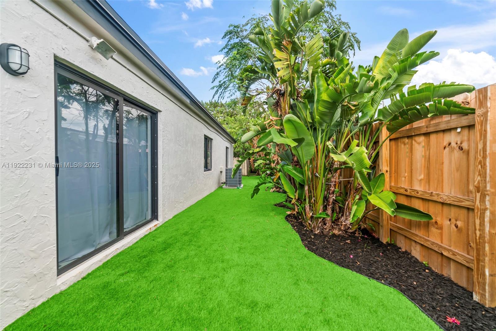 1671 Northeast 174th Street, Unit 1671 North Miami Beach, FL 33162 - Photo 2 of 21 a view of back yard of the house