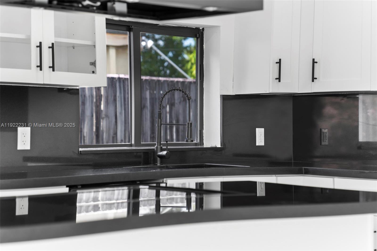 1671 Northeast 174th Street, Unit 1671 North Miami Beach, FL 33162 - Photo 5 of 21 a kitchen with a sink and a window