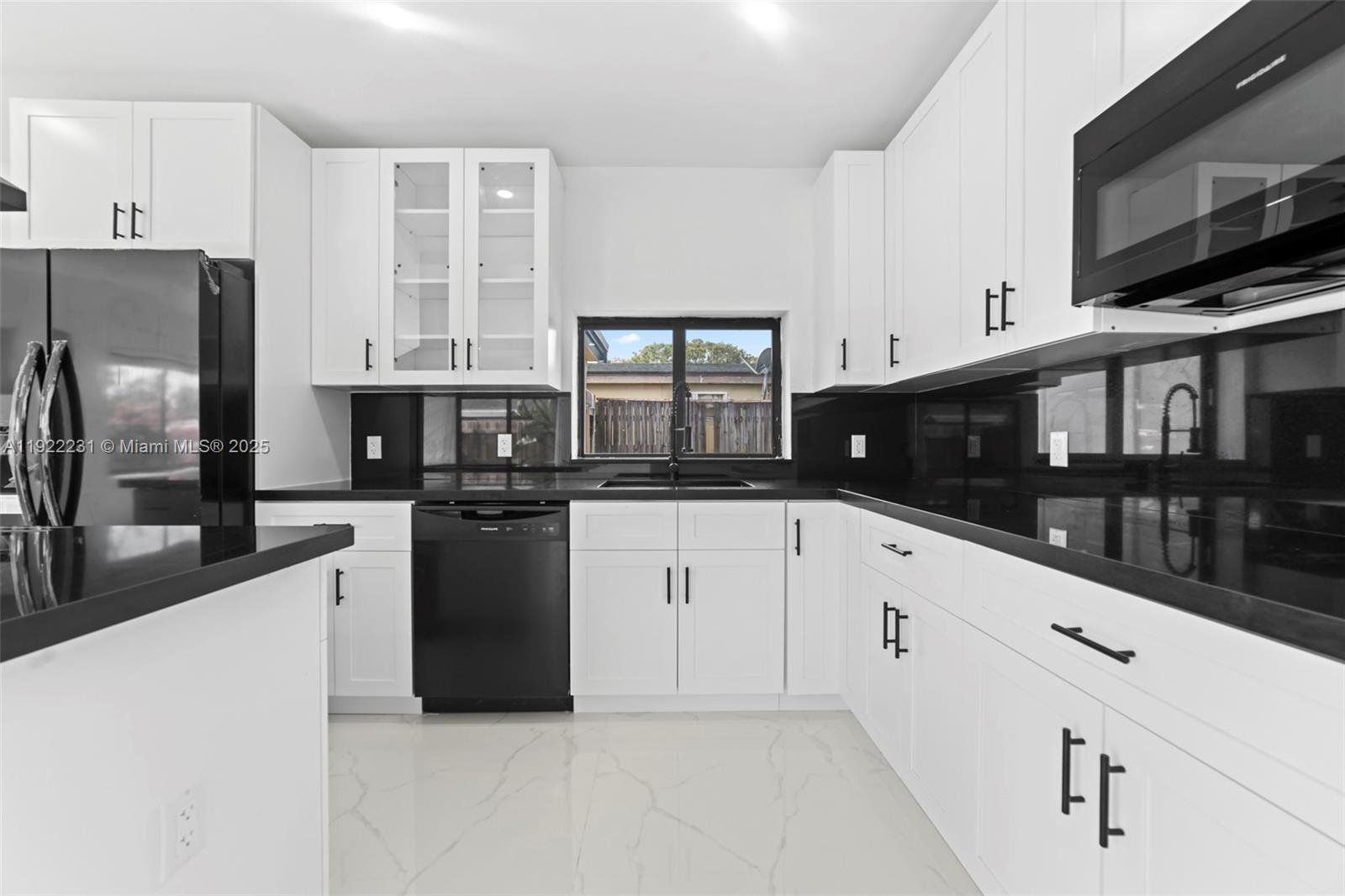 1671 Northeast 174th Street, Unit 1671 North Miami Beach, FL 33162 - Photo 6 of 21 a kitchen with stainless steel appliances a refrigerator sink and white cabinets