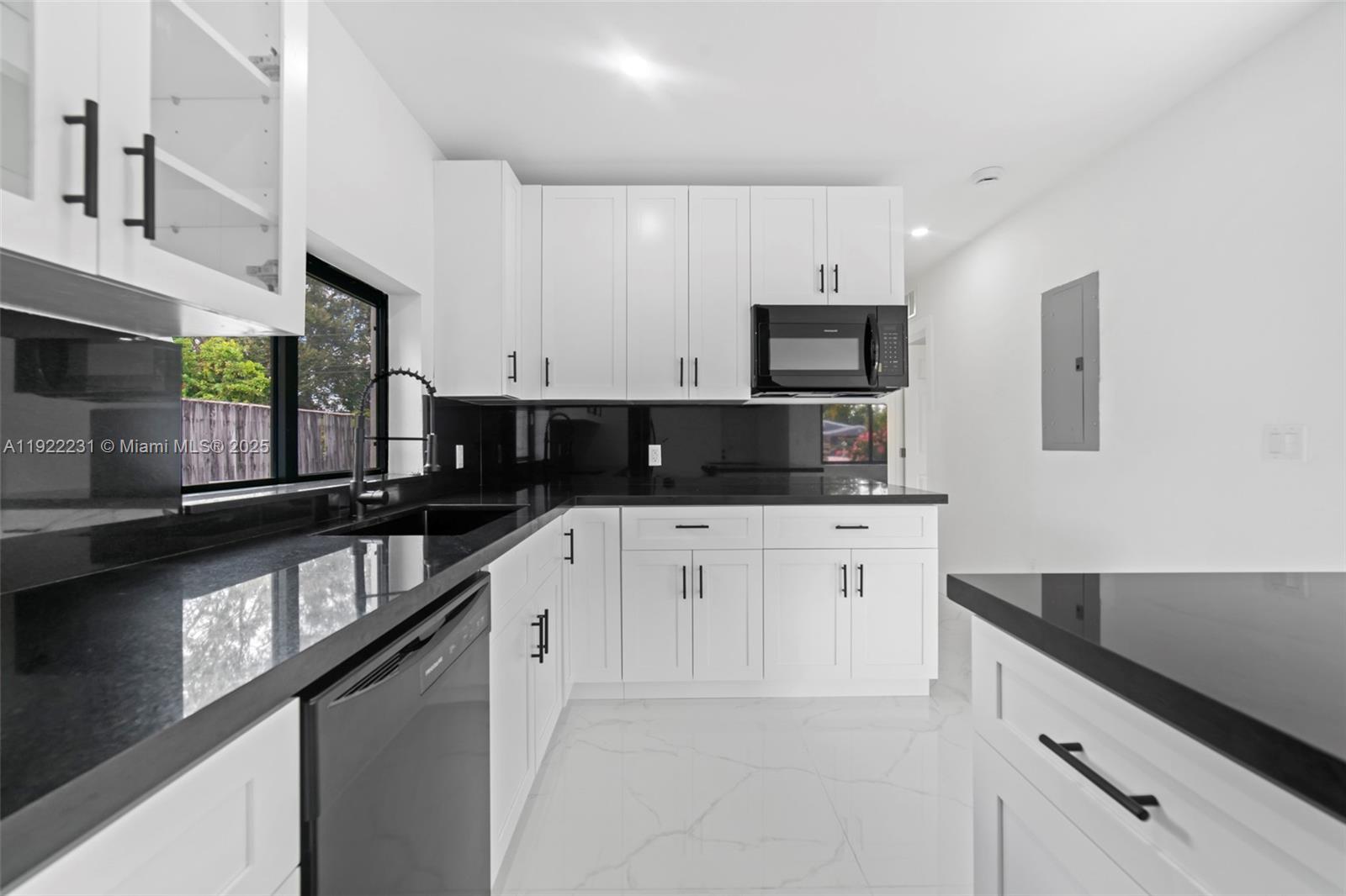 1671 Northeast 174th Street, Unit 1671 North Miami Beach, FL 33162 - Photo 7 of 21 a kitchen with stainless steel appliances granite countertop a sink a stove and a refrigerator