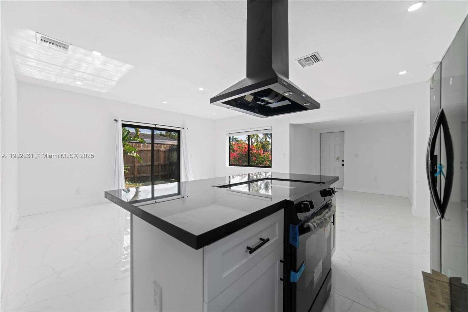 1671 Northeast 174th Street, Unit 1671 North Miami Beach, FL 33162 - Photo 9 of 21 a kitchen with stainless steel appliances a sink and a refrigerator