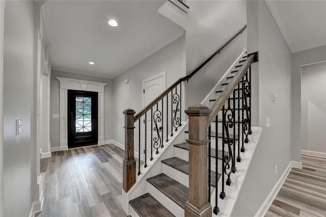 a kitchen that has a sink a stove top oven a refrigerator and white cabinets