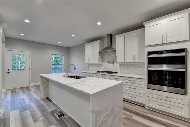 a view of an empty room with a fireplace and a window