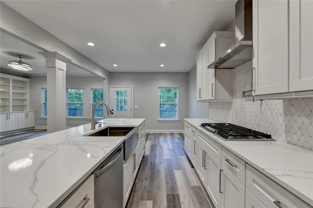 a view of an empty room with wooden floor fireplace and a window
