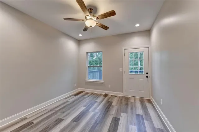 a bathroom with a granite countertop sink toilet and mirror