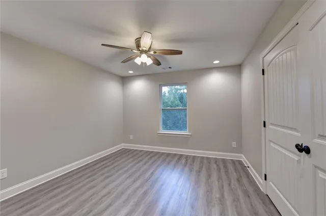 a view of a livingroom with wooden floor and a window
