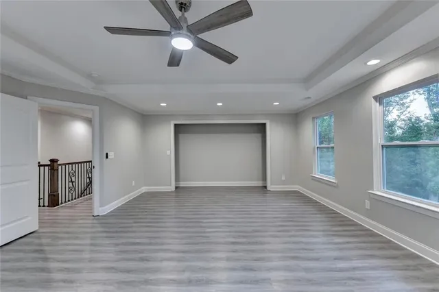 a balcony with wooden floor and trees in the back