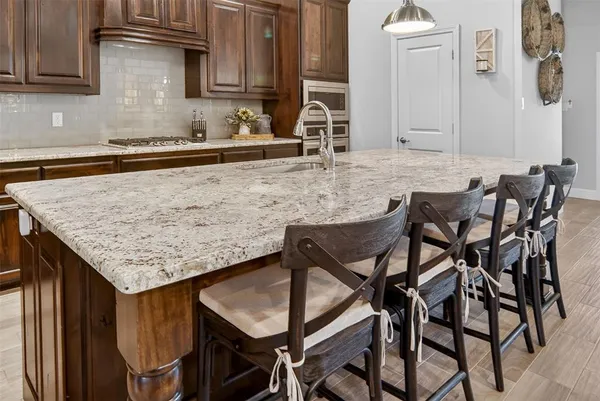 a kitchen with a table chairs and cabinets