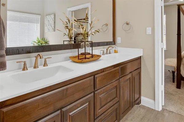 a large bed in a bedroom next to a window