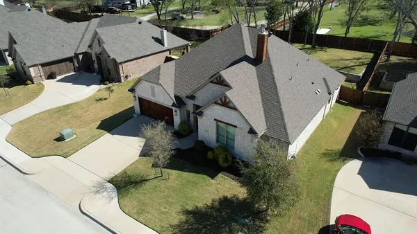 an aerial view of a house with a yard
