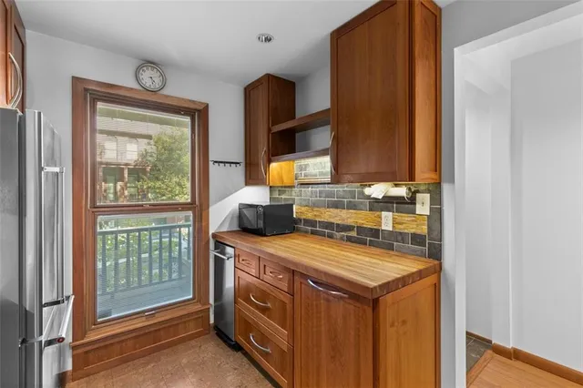 a kitchen with stainless steel appliances granite countertop a refrigerator and a sink