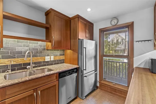 a kitchen with granite countertop a sink and a stove