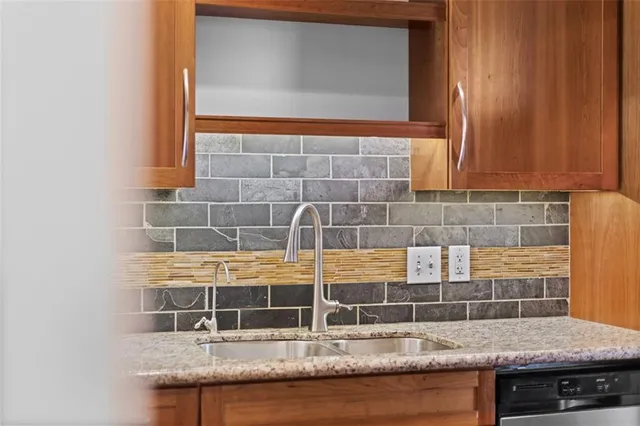 a kitchen with a stove a sink and a microwave