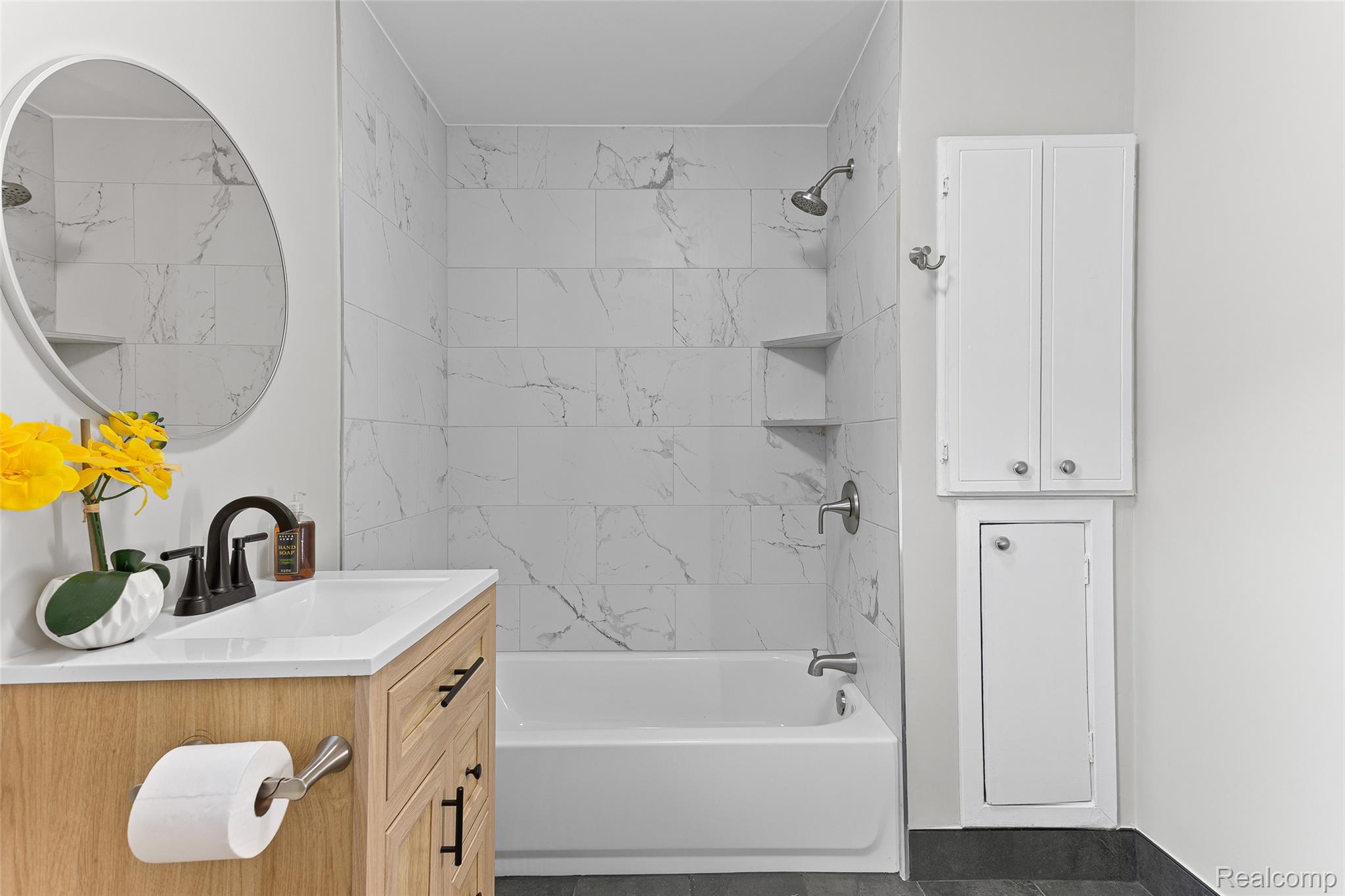 35025 Wick Road Romulus, MI 48174 - Photo 14 of 22 Wood-finish vanity with a white countertop and basin sink