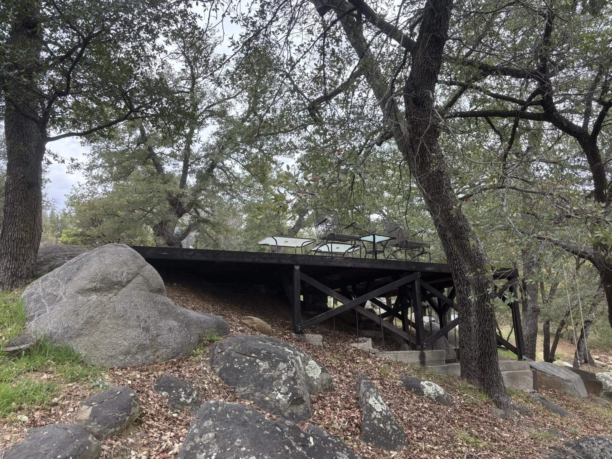7317 Starlight Way Julian, CA 92036 - Photo 7 of 19 a view of a wooden bench and trees in the background