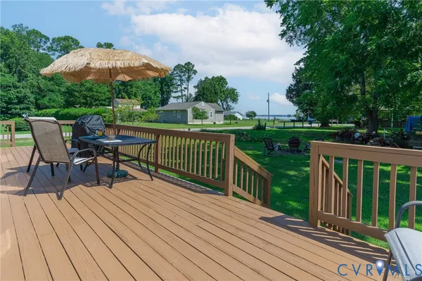 a view of a chairs and table on the wooden deck