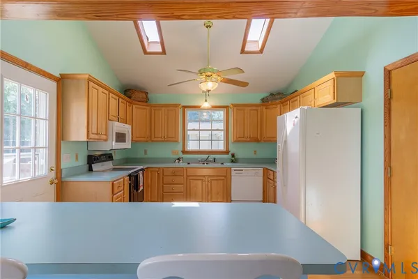 a living room with stainless steel appliances granite countertop furniture and a kitchen view