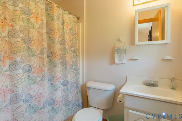 a white toilet sitting next to a bathroom sink