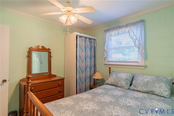 a bedroom with a bed and a mirror on dresser