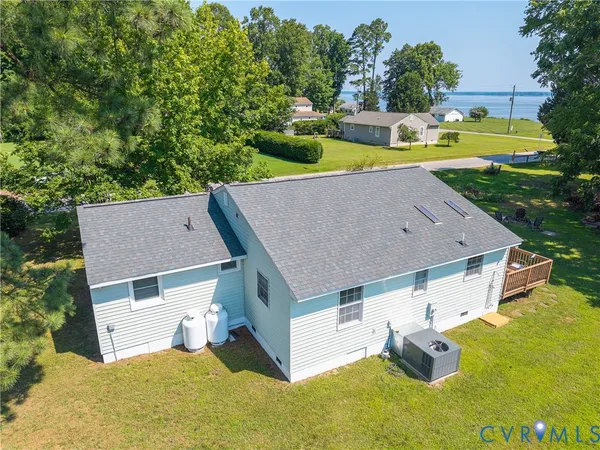 an aerial view of a house with swimming pool garden and patio