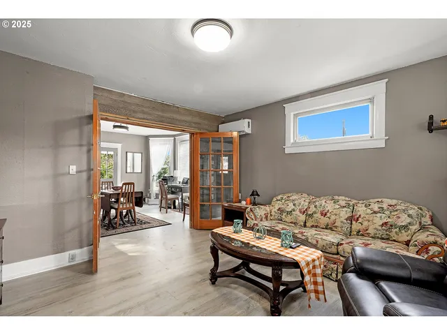 a view of living room and kitchen with wooden floor