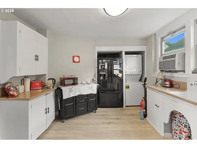 a kitchen with stainless steel appliances a stove a sink and a refrigerator