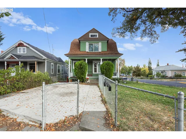 a front view of a house with a garden and plants