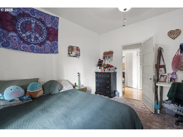 a living room with furniture a rug and a toilet