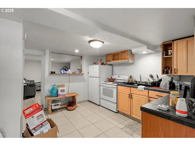 a kitchen with stainless steel appliances kitchen island granite countertop a sink and cabinets