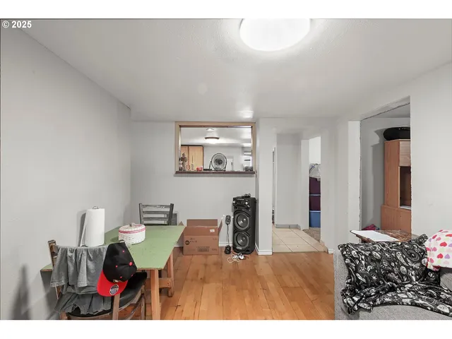 a living room with furniture and a dining area with kitchen view