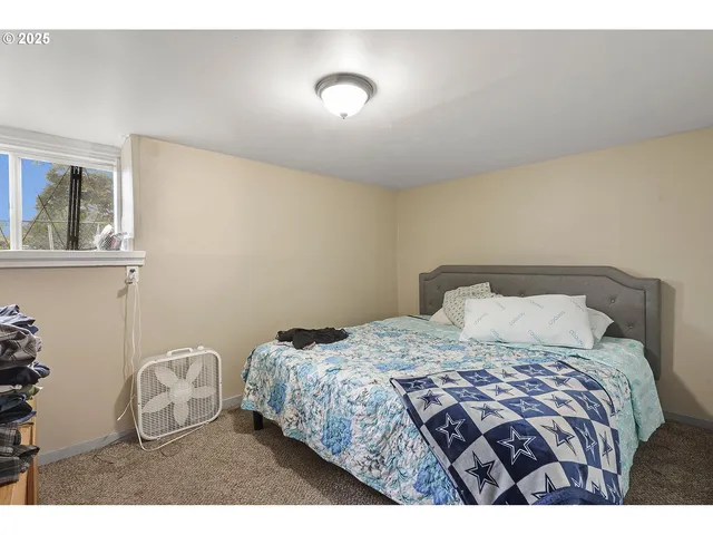 a bedroom with a bed and with a night stand