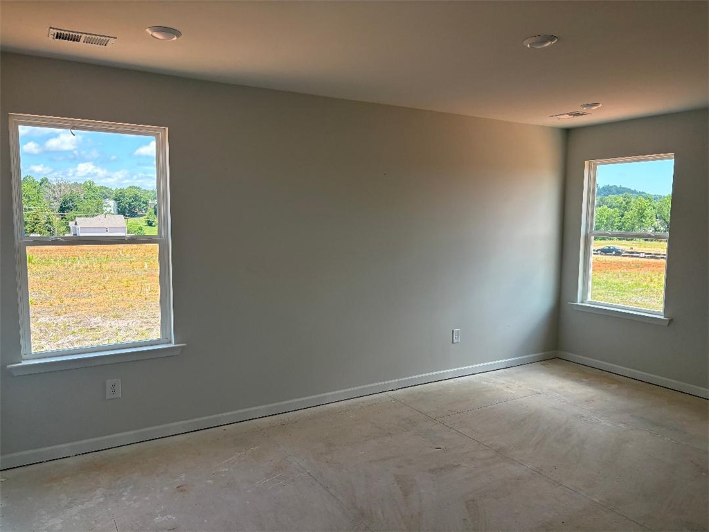 129 Cedar Shoals Easley, SC 29640 - Photo 14 of 31 Two large windows frame verdant vistas in this peaceful, newly constructed space.