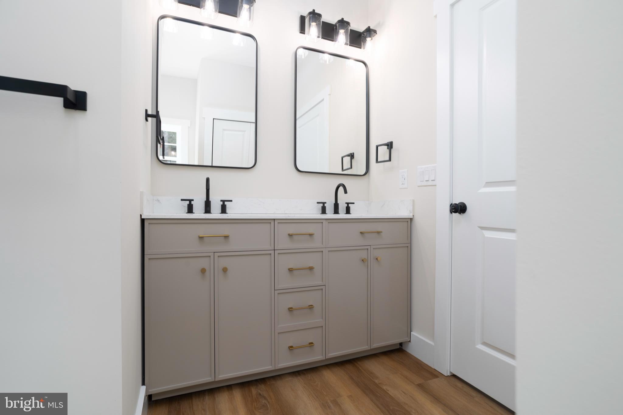 Clark Corner Road Centreville, MD 21617 - Photo 17 of 43 a bathroom with a double vanity sink and mirror