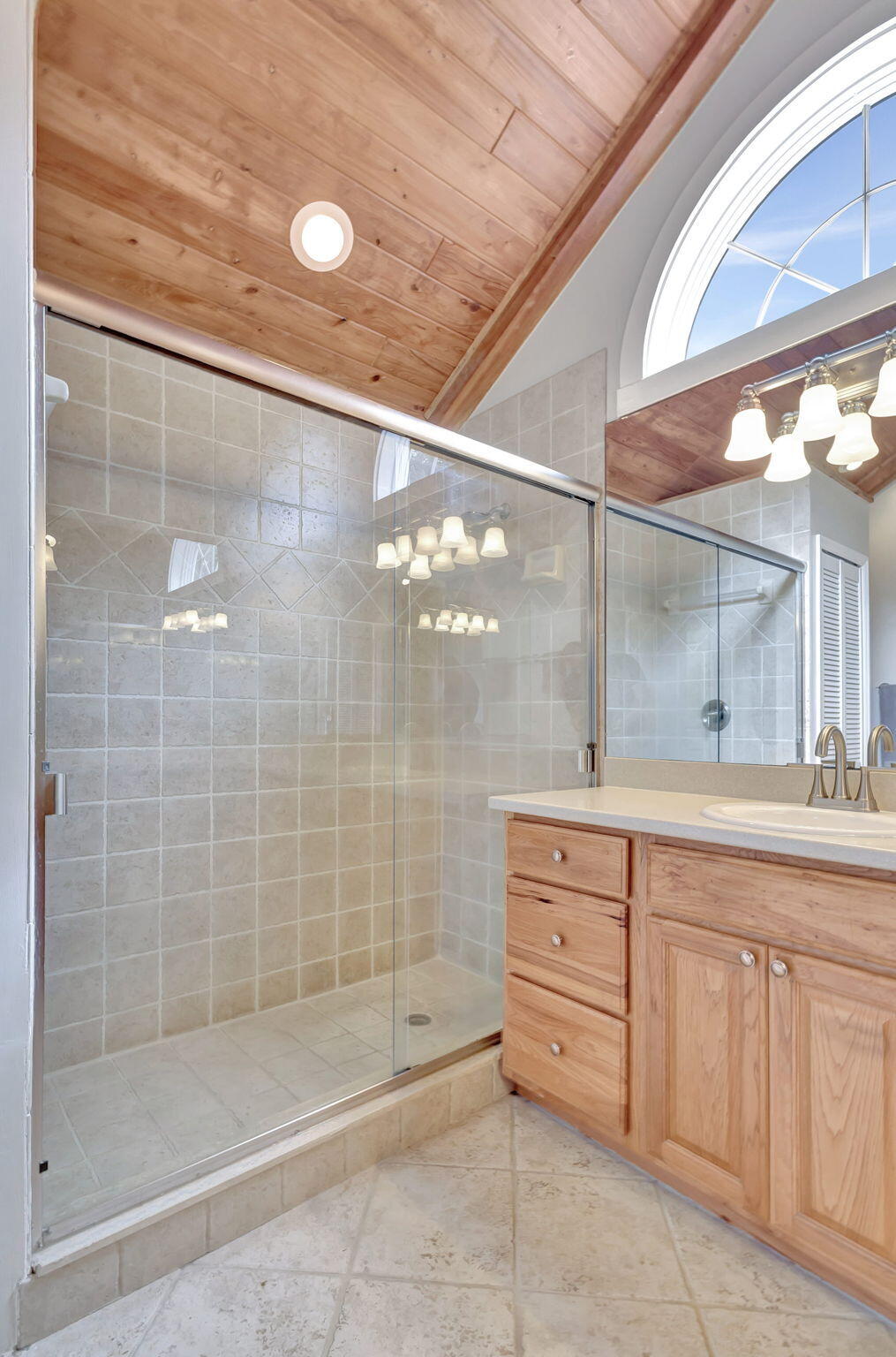 18199 April Lane Jupiter, FL 33458 - Photo 31 of 70 a bathroom with a granite countertop sink a mirror and shower