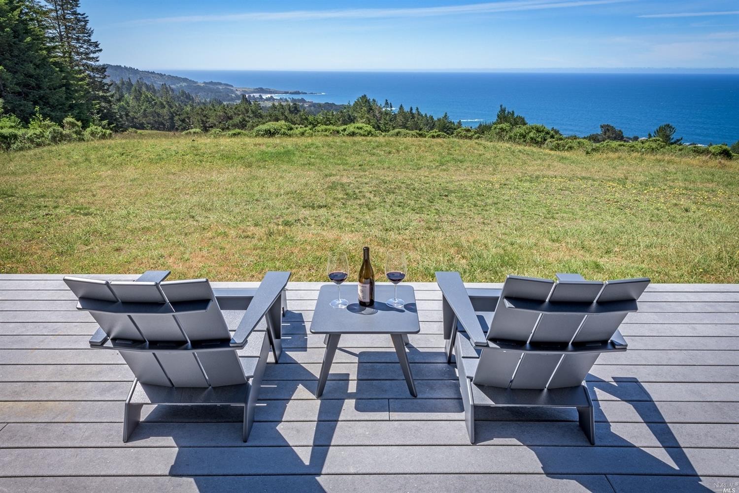 a view of a patio with couches chairs under an umbrella