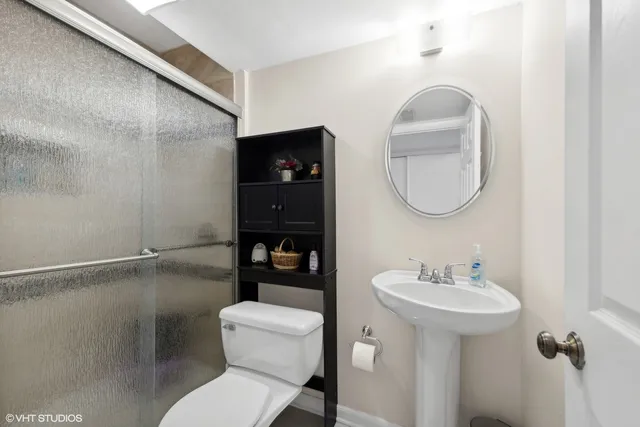 a bathroom with a toilet sink and mirror