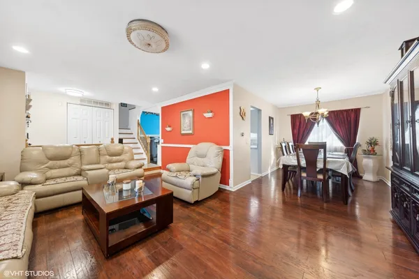 a living room with furniture and wooden floor