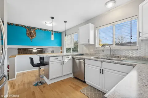 a kitchen with a sink cabinets and window