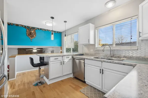 a kitchen with a sink cabinets and window