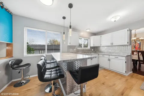 a kitchen with stainless steel appliances granite countertop a stove sink and cabinets
