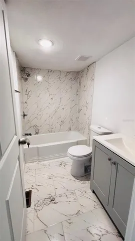 a bathroom with a sink a toilet and a tub