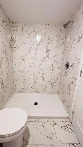 a bathroom with a bathtub and a toilet