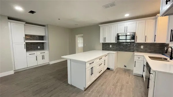 a kitchen with stainless steel appliances granite countertop a stove and a sink