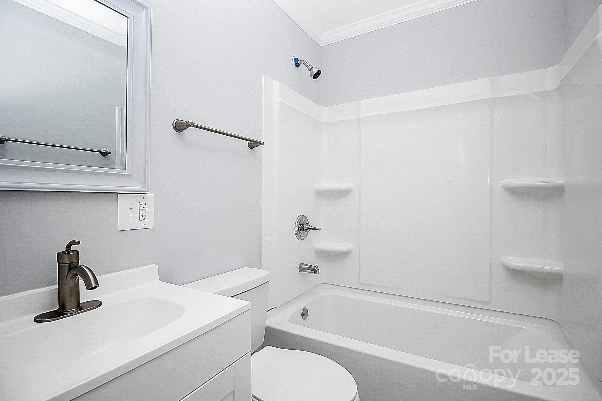 1027 Little Avenue, Unit D Gastonia, NC 28052 - Photo 17 of 20 a bathroom with a sink a toilet and a bathtub