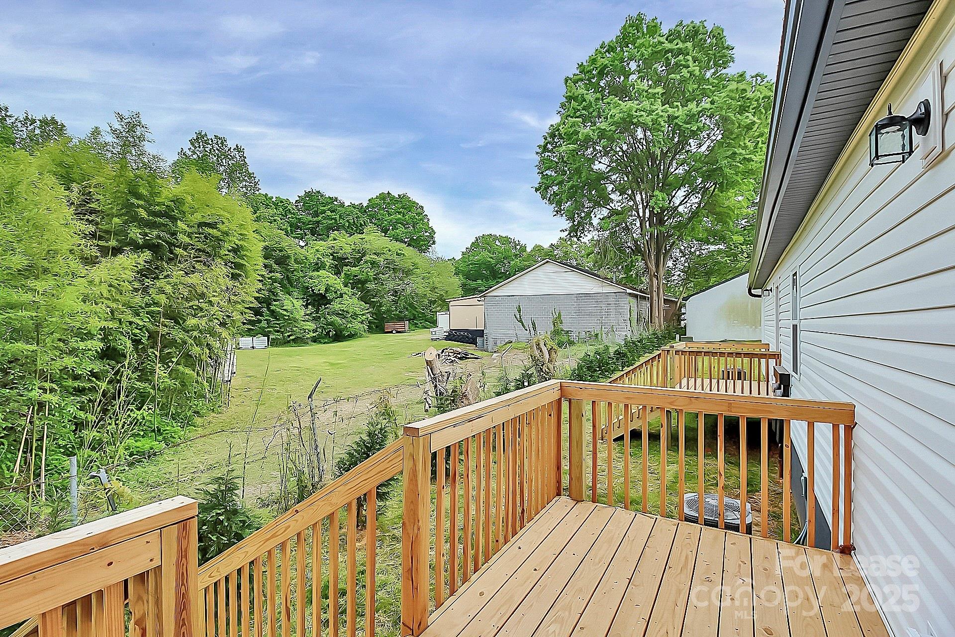 1027 Little Avenue, Unit D Gastonia, NC 28052 - Photo 18 of 20 a view of a house with wooden deck and trees
