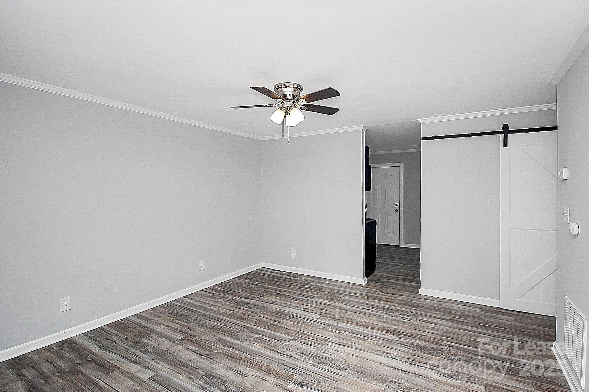 1027 Little Avenue, Unit D Gastonia, NC 28052 - Photo 2 of 20 wooden floor in an empty room with a window