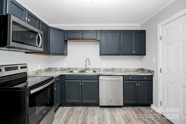 a kitchen with a sink stove and microwave