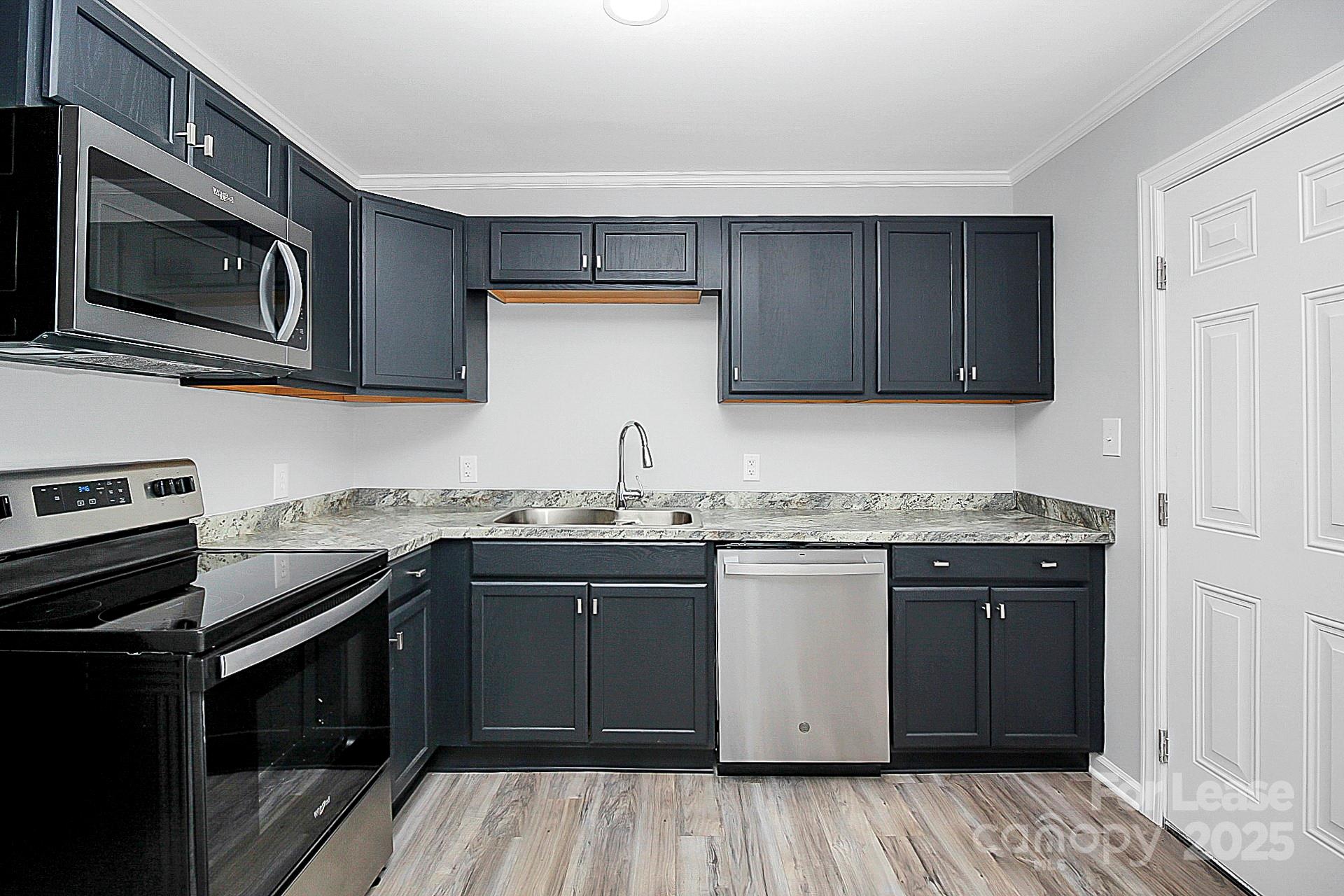 1027 Little Avenue, Unit D Gastonia, NC 28052 - Photo 8 of 20 a kitchen with a sink stove and microwave