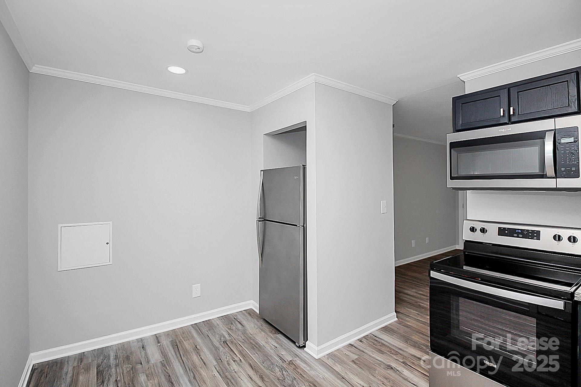 1027 Little Avenue, Unit D Gastonia, NC 28052 - Photo 9 of 20 a kitchen with a refrigerator and a stove top oven
