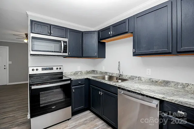 a kitchen with a sink stove and microwave